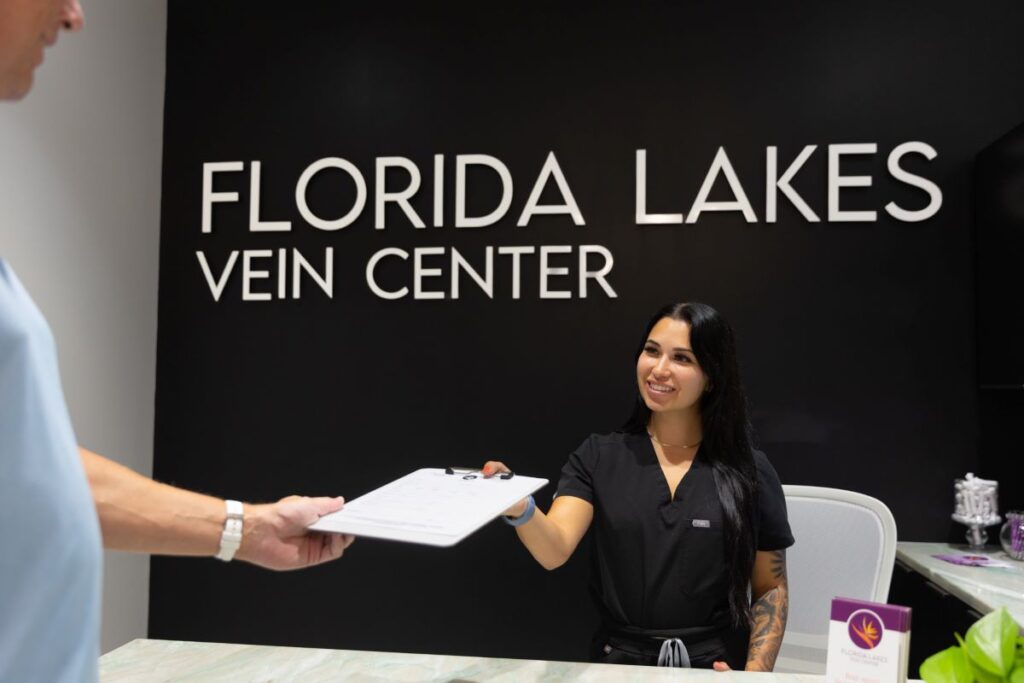 Front desk person welcoming new patient seeking a Vein Doctor in North Port